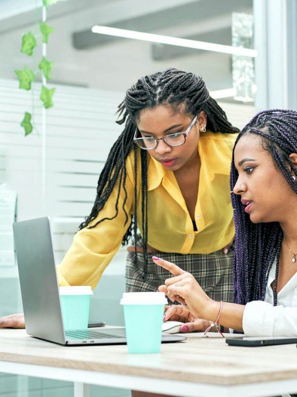 two-young-black-women-reviewing-analytical-data-on-various-electronic-devices-.jpg